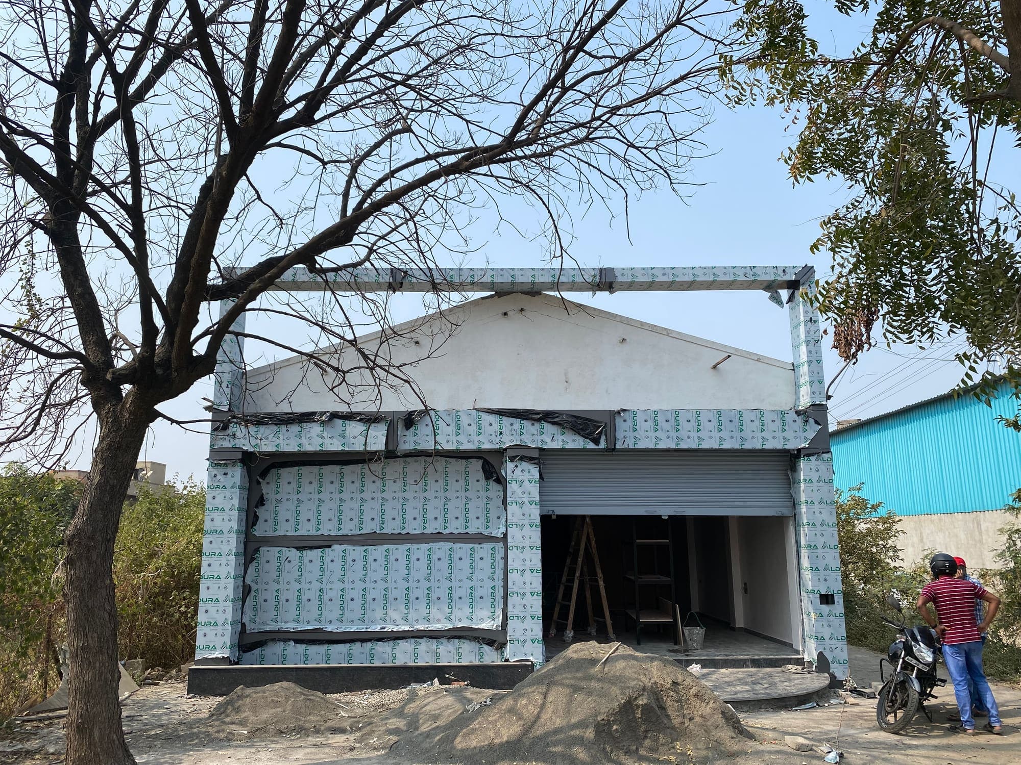 Front elevation of the stockyard during facade cladding
