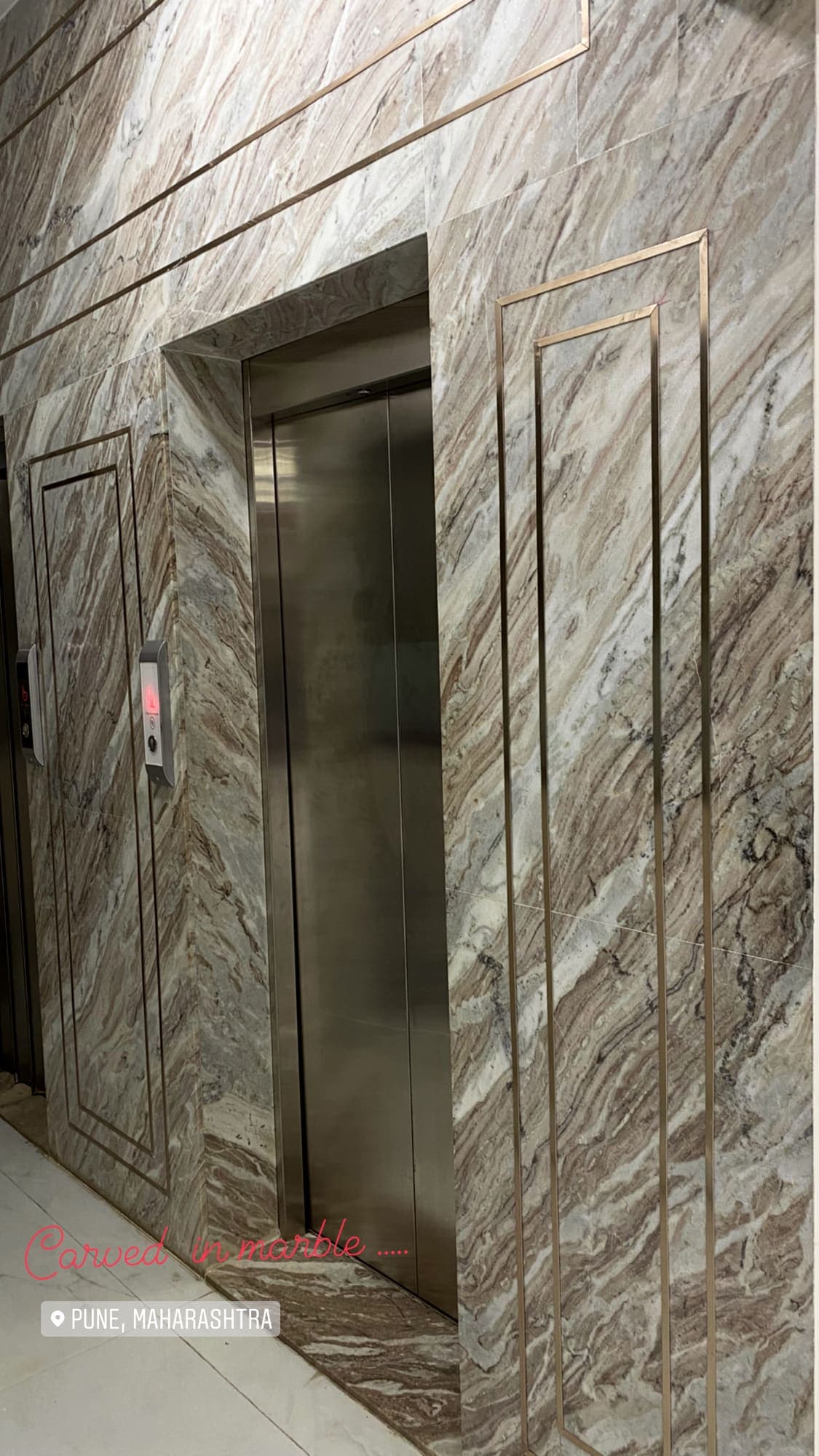 Lift lobby clad in veined stone
