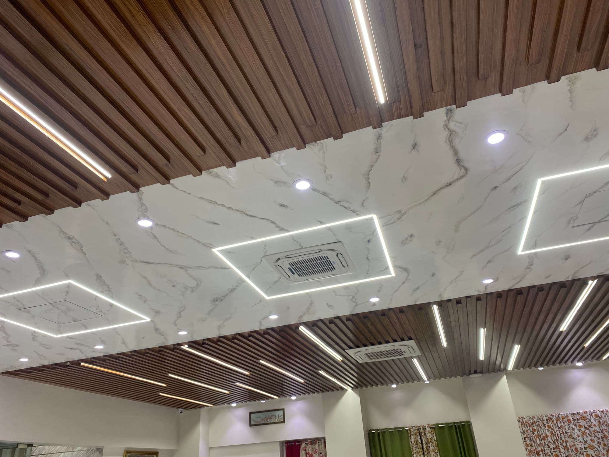 Showroom ceiling with timber slats and linear lights
