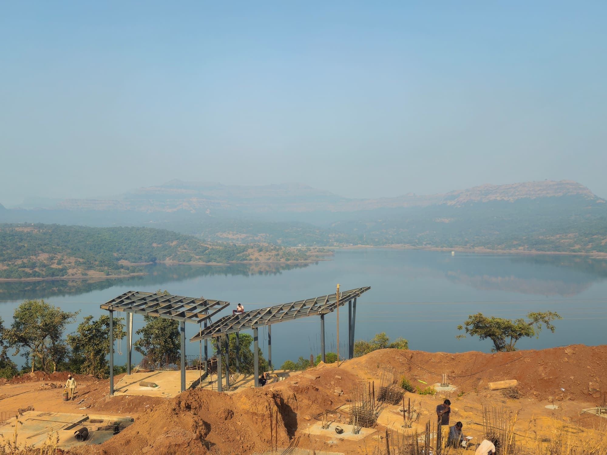 Steel framing on site with the lake and hills beyond