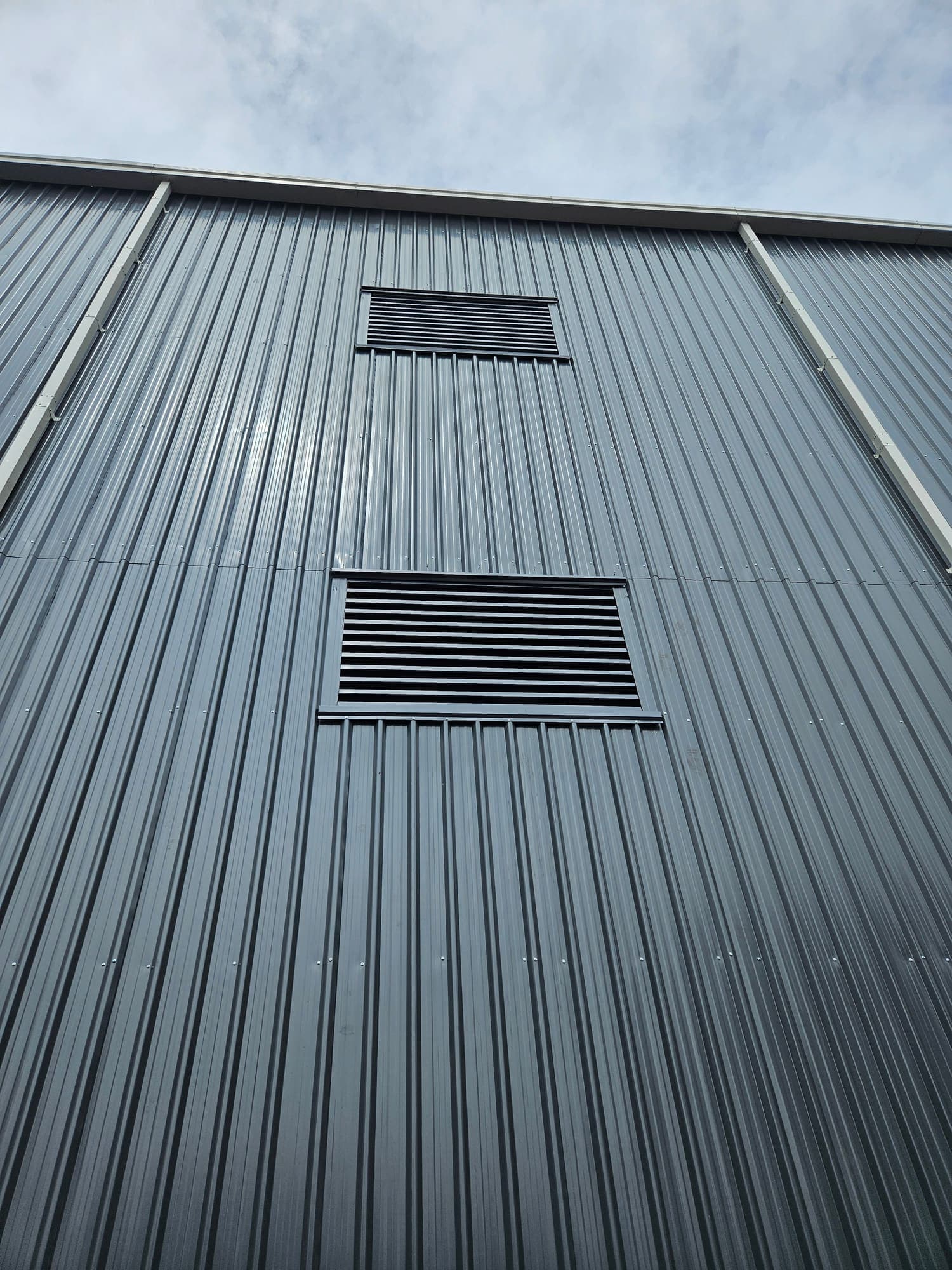 Profiled wall cladding with louvred openings