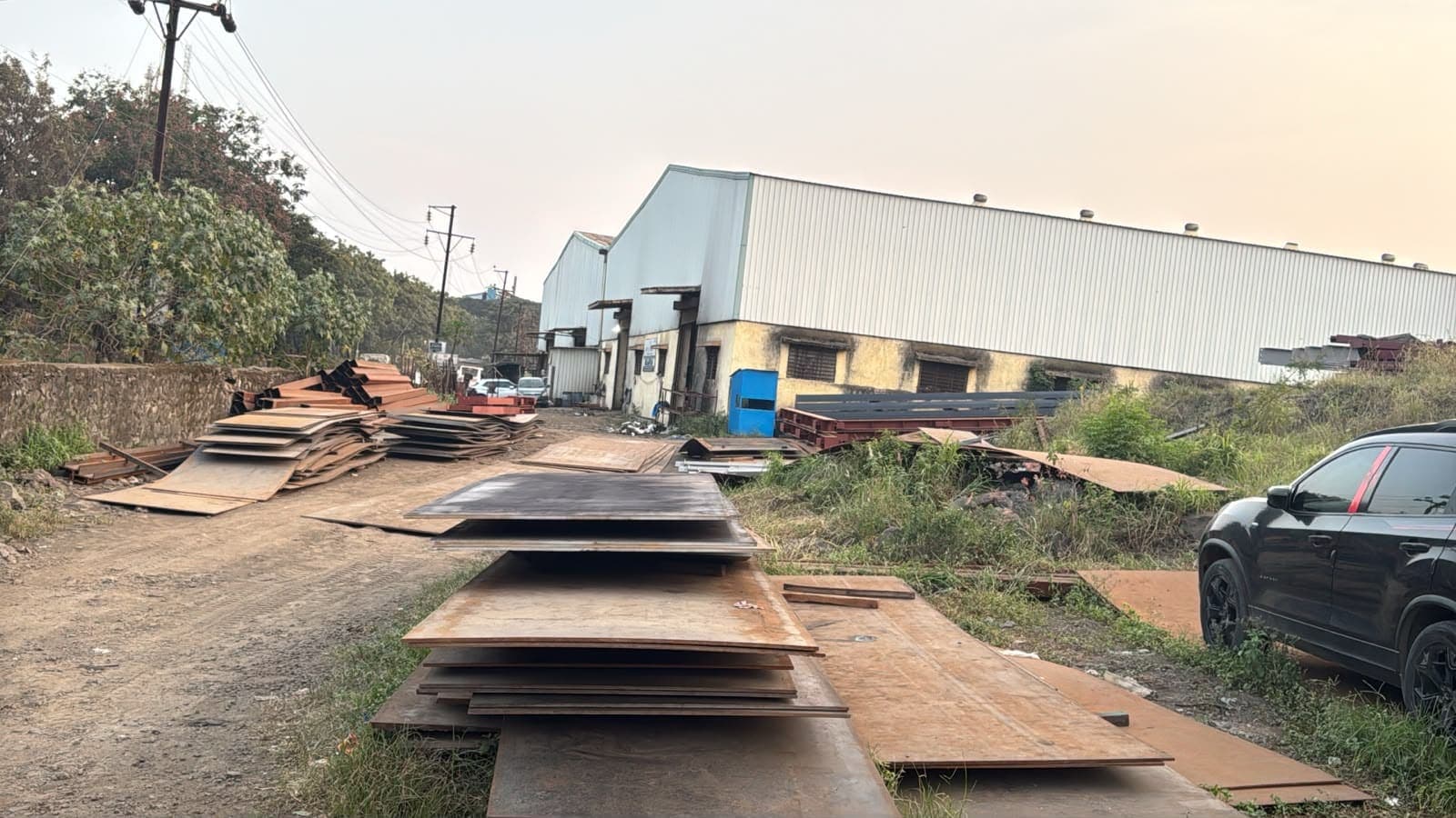 Raw material stock yard with steel plate stacked by thickness