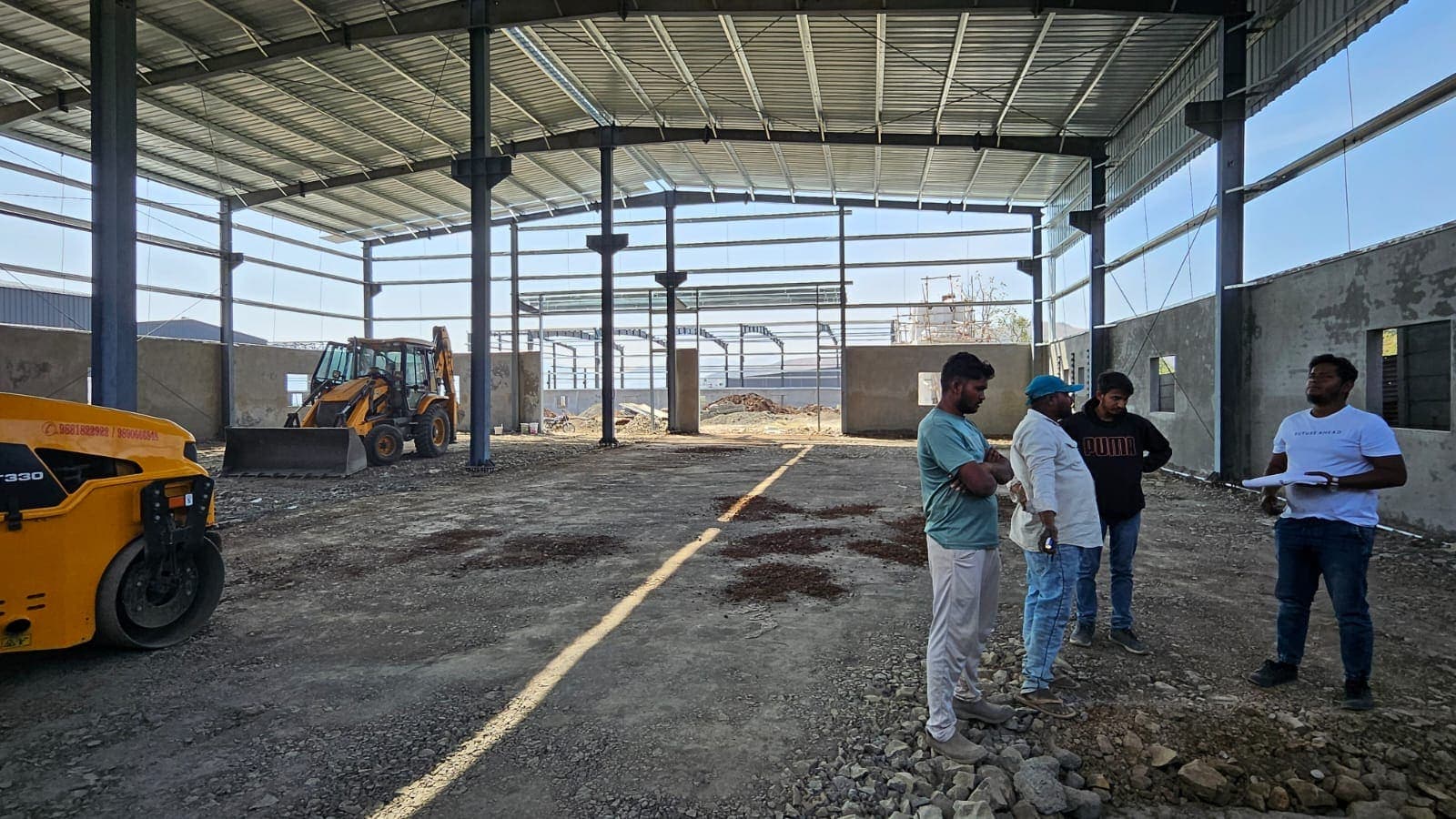 Site team inside the steel-framed manufacturing hall